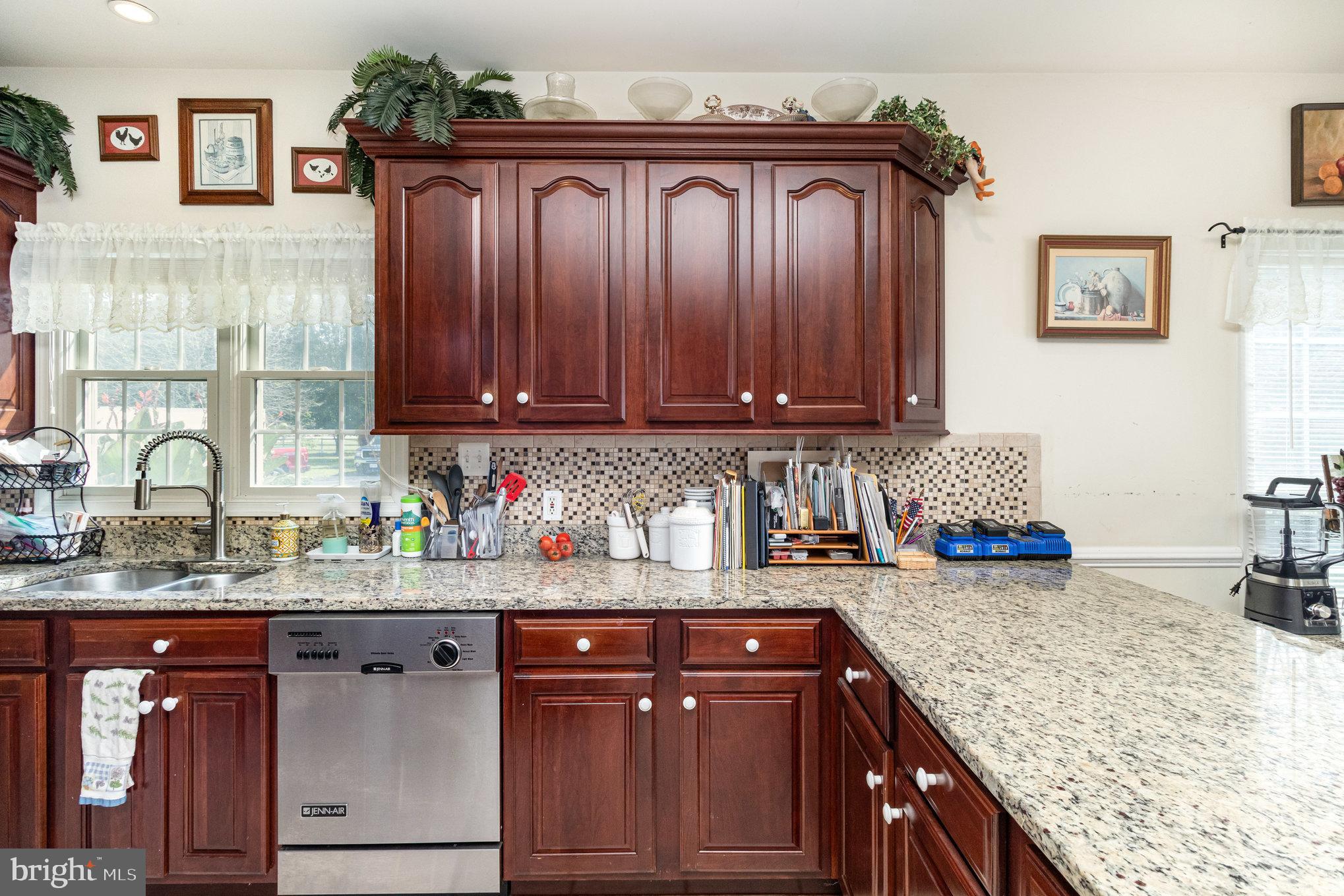 13467 Ellis Way King George, VA 22485 - Photo 16 of 81 a kitchen with granite countertop a sink a stove and wooden cabinets