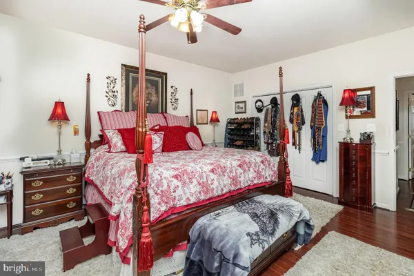 a bedroom with a bed window and a flat screen tv