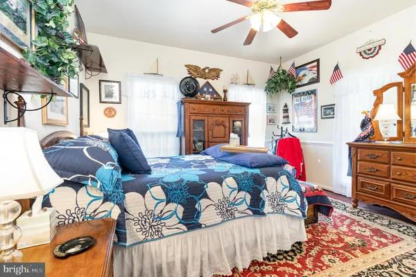 a living room with furniture and a baby crib