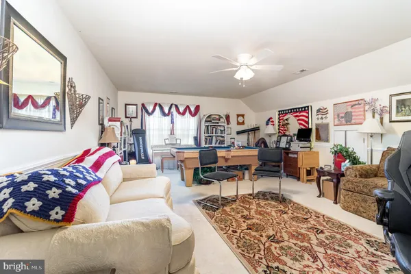 a view of yard with swimming pool and trees in the background