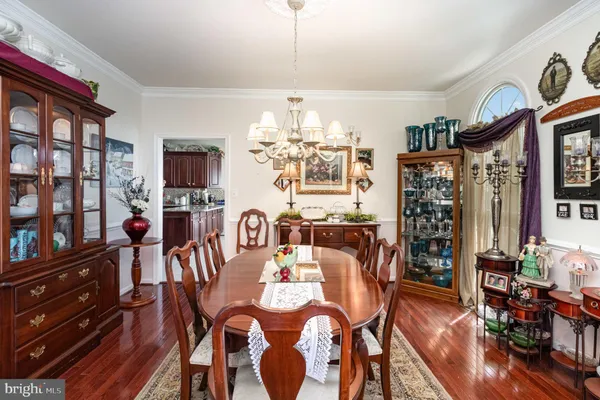 a view of a dining room with furniture and chandelier