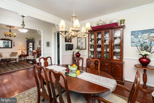 a view of a dining room with furniture and chandelier