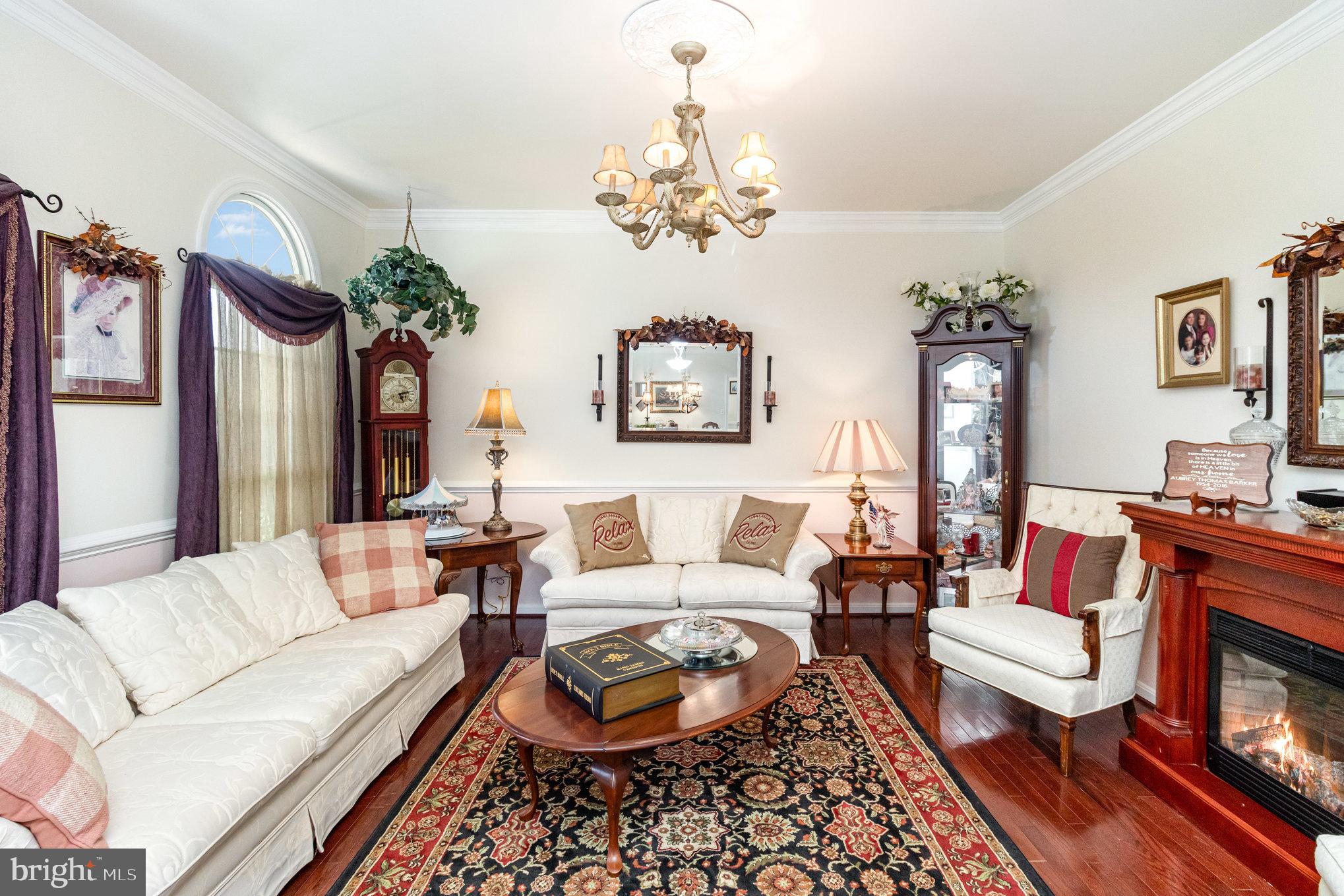 13467 Ellis Way King George, VA 22485 - Photo 9 of 81 a living room with furniture a chandelier and a fireplace