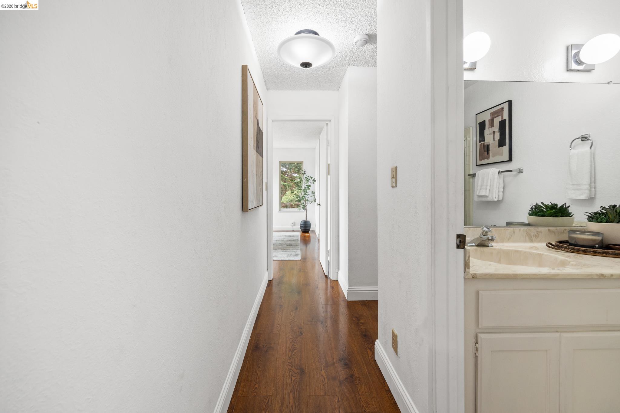 201 Vista Heights Road El Cerrito, CA 94530 - Photo 18 of 32 Hallway featuring wood-finish flooring, white walls, and a recessed ceiling light