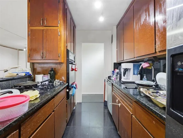 a kitchen with stainless steel appliances granite countertop a stove and a refrigerator