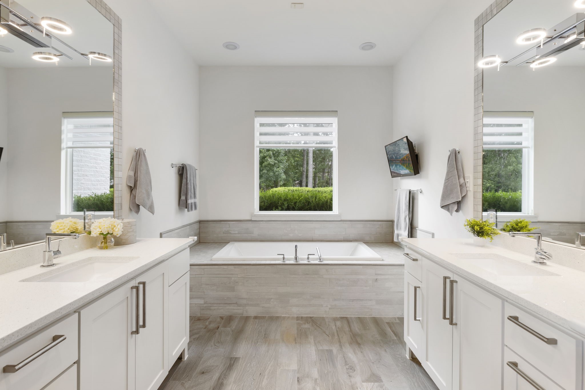 3918 Almond Court Spring, TX 77386 - Photo 20 of 42 a bathroom with a bathtub a double vanity sink and window