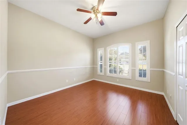 a view of a room with an empty space and windows