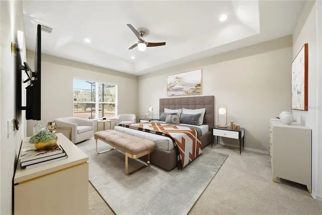 a view of a big room with windows and chandelier fan