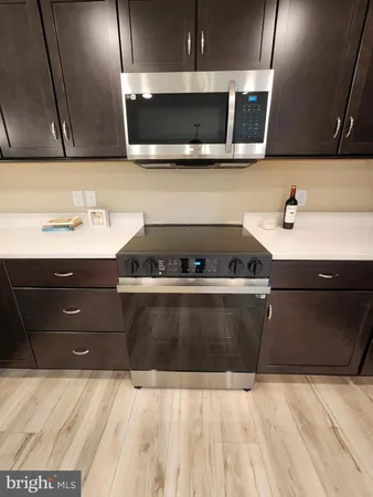 a kitchen with a sink and a stove top oven