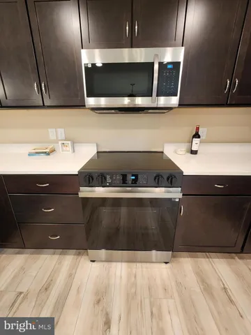 a kitchen with a sink and a stove top oven