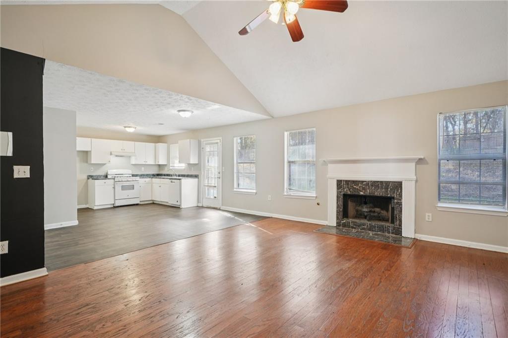 1443 Pebble Ridge Lane Hampton, GA 30228 - Photo 7 of 24 an empty room with wooden floor fireplace and windows