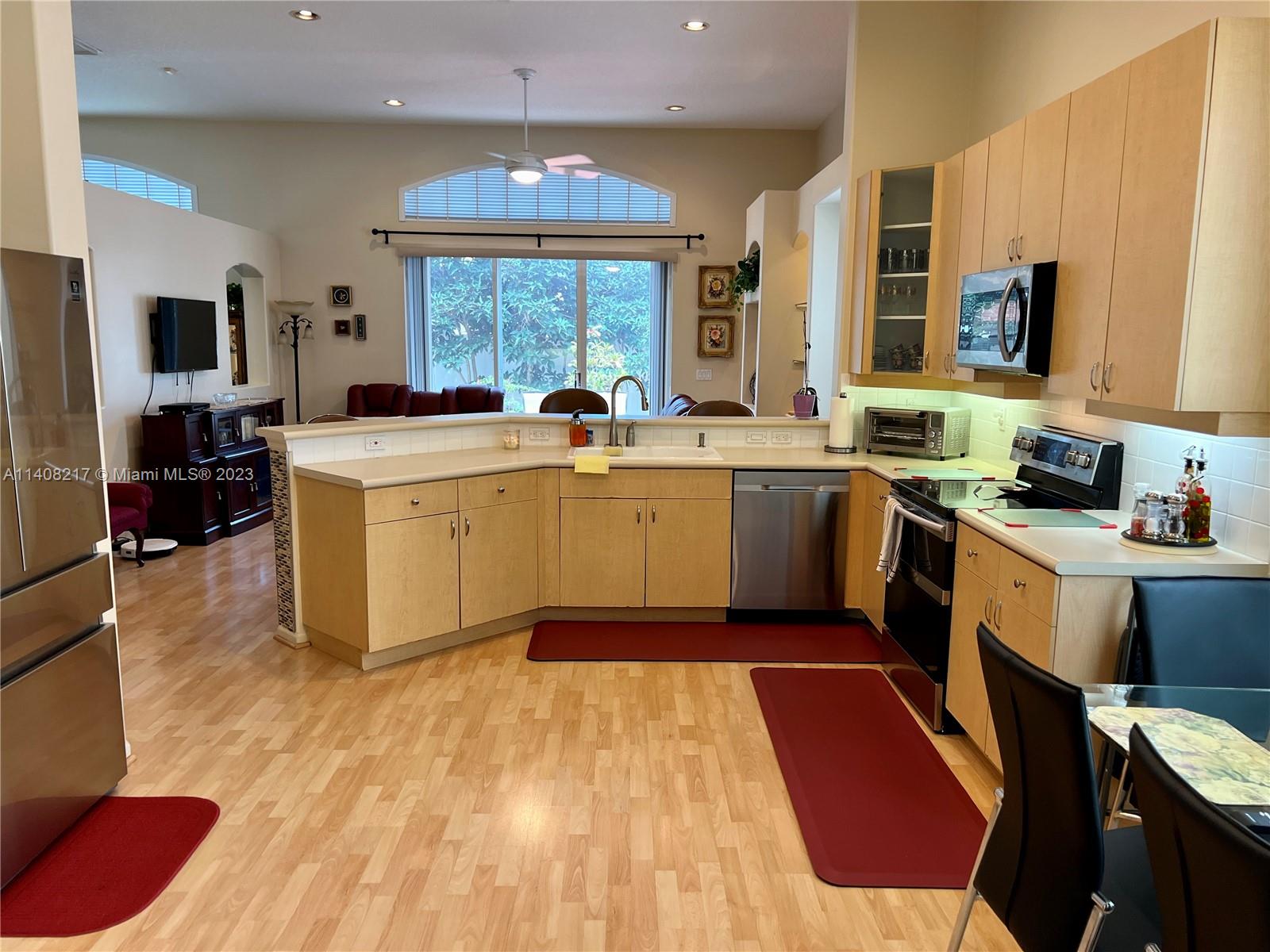 Oakridge Hollywood, FL 33312 - Photo 12 of 33 a kitchen with a sink stove and cabinets