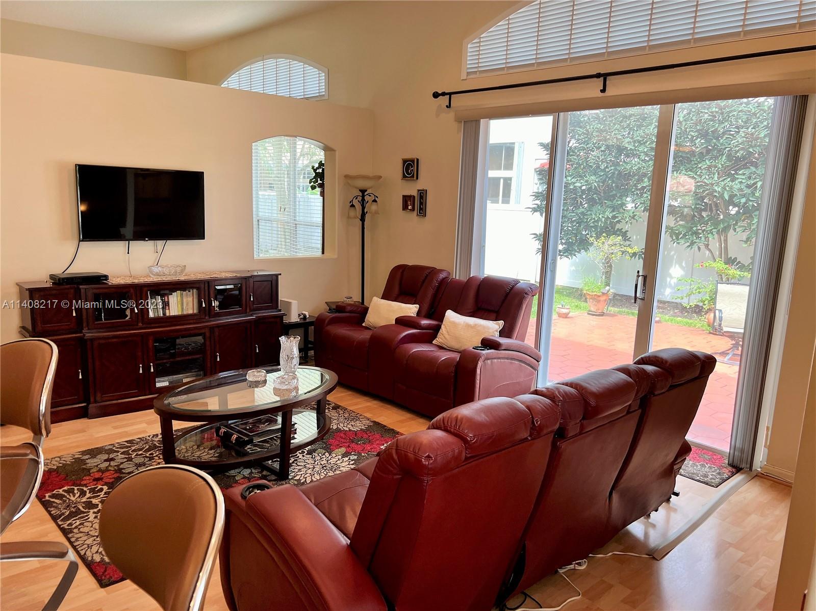 Oakridge Hollywood, FL 33312 - Photo 16 of 33 a living room with furniture a flat screen tv and a window