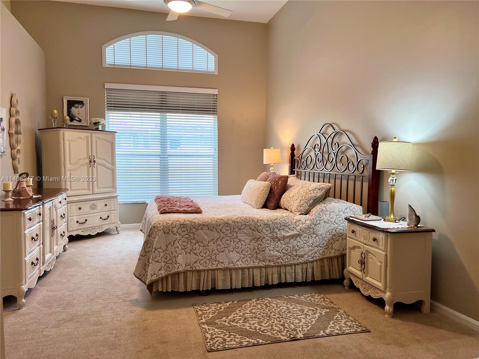 Oakridge Hollywood, FL 33312 - Photo 17 of 33 a bedroom with a bed a mirror and lamp