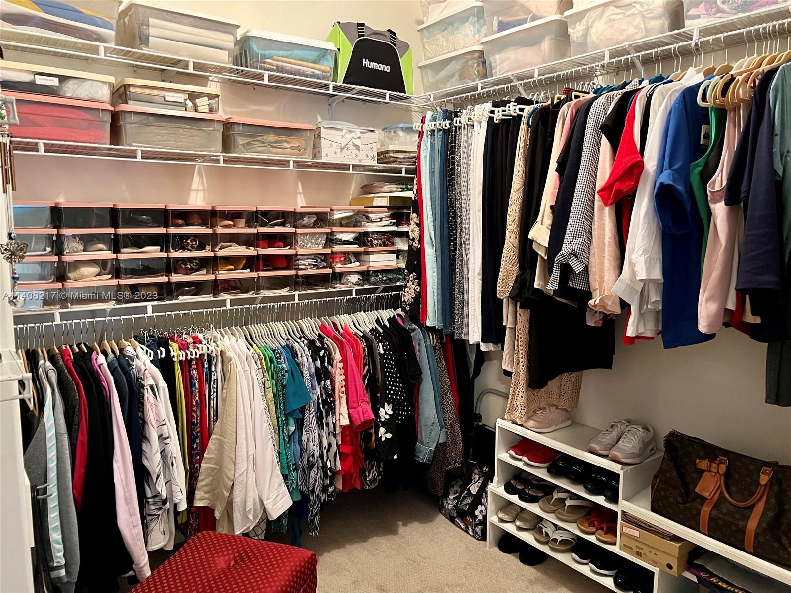 Oakridge Hollywood, FL 33312 - Photo 19 of 33 a view of walk in closet with clothes and shoes