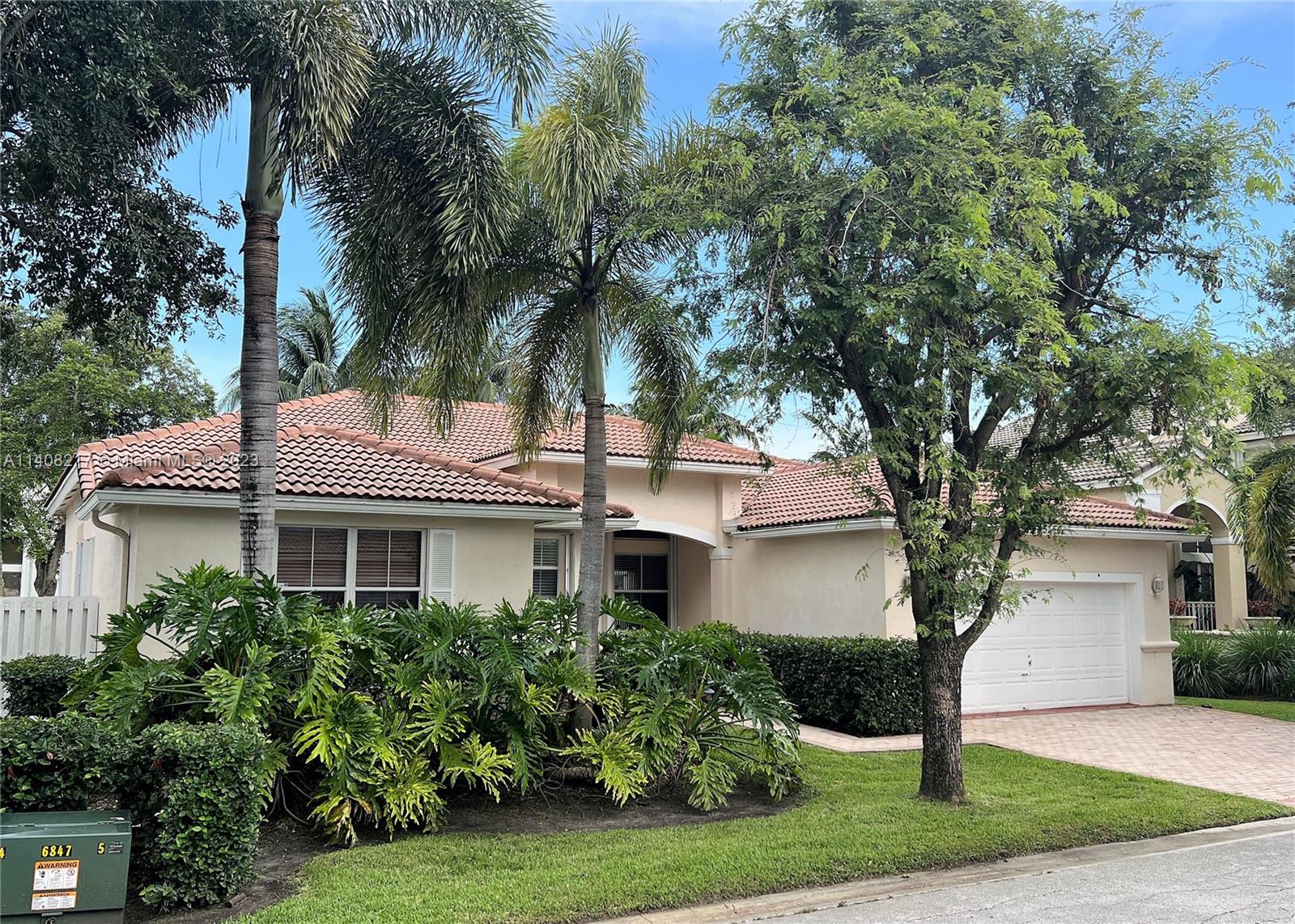 Oakridge Hollywood, FL 33312 - Photo 2 of 33 a front view of a house with a yard and garage