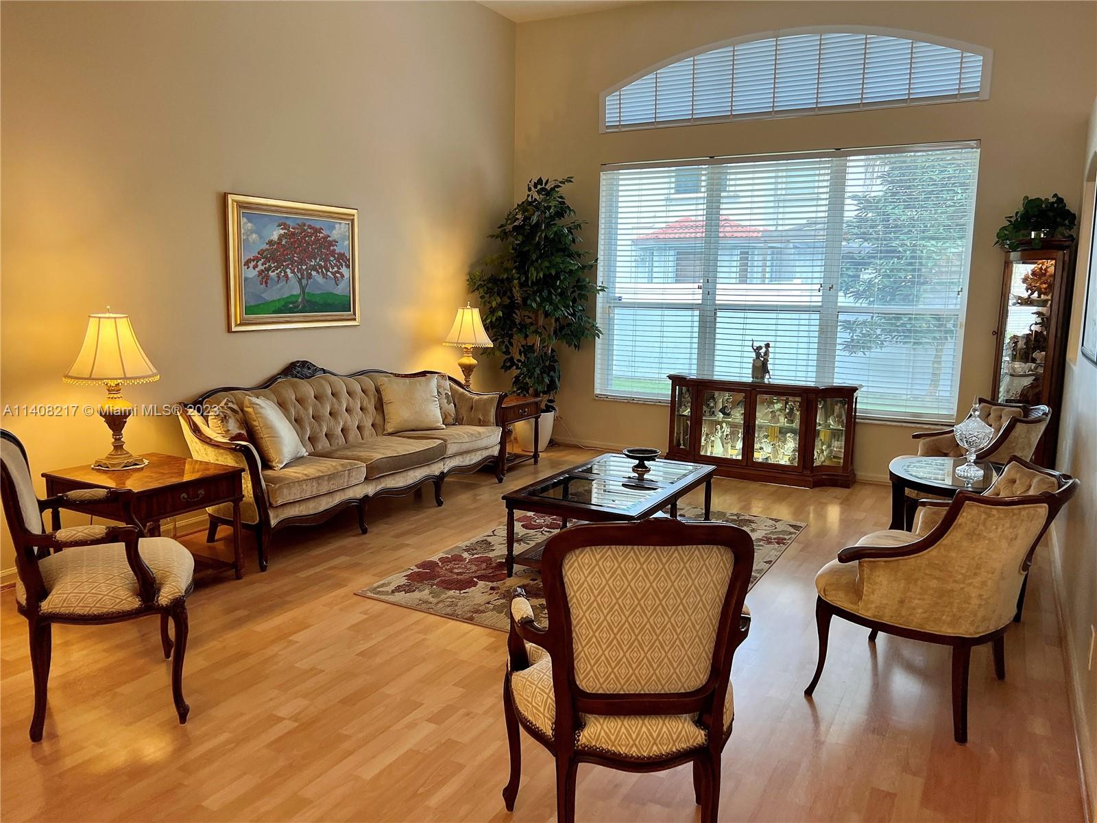 Oakridge Hollywood, FL 33312 - Photo 10 of 33 a living room with furniture a flat screen tv and a large window