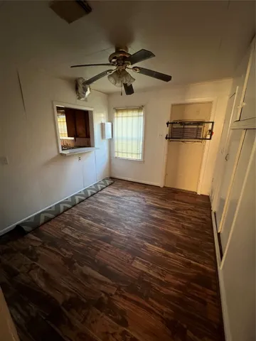 a view of an empty room with a window and a fireplace