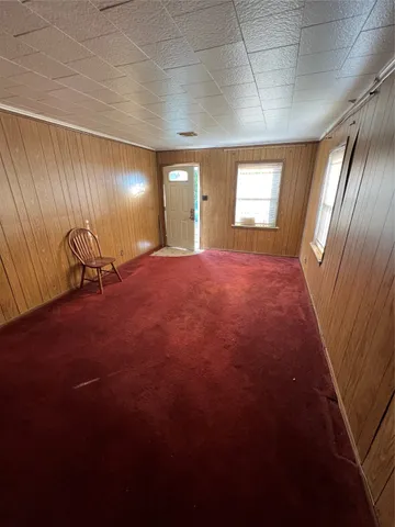 a view of a room with a ceiling fan and window