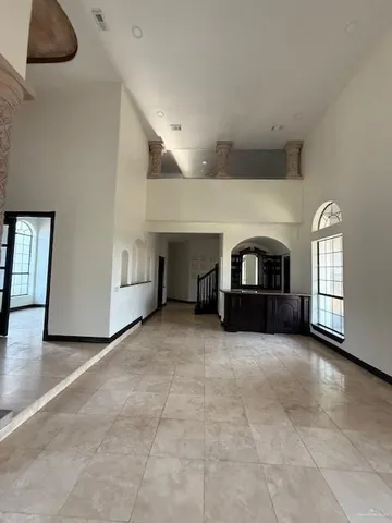 a view of an empty room with window and cabinet
