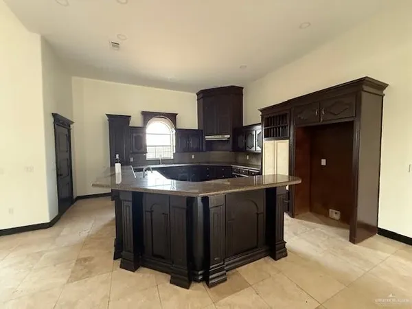 a spacious bathroom with a granite countertop sink a mirror and shower