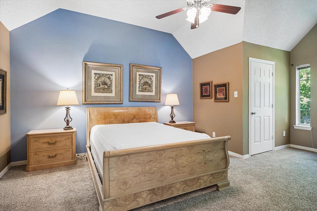 14592 Greenleaf Court Addison, TX 75001 - Photo 14 of 30 a bedroom with a bed and a chandelier