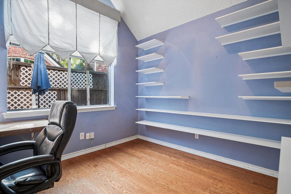 14592 Greenleaf Court Addison, TX 75001 - Photo 18 of 30 a room with a chair and a potted plant