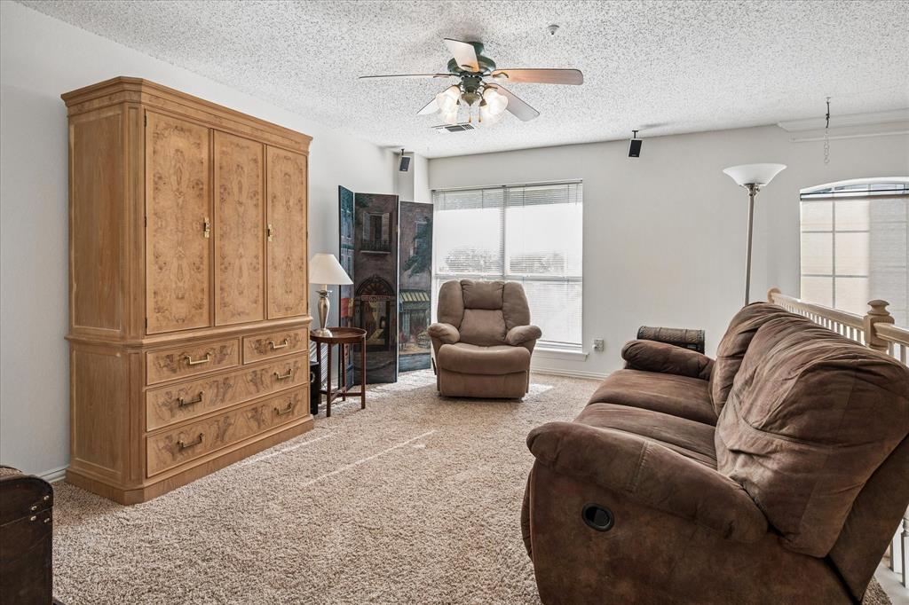 14592 Greenleaf Court Addison, TX 75001 - Photo 19 of 30 a living room with furniture a ceiling fan and a window