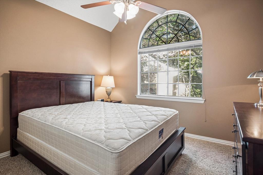 14592 Greenleaf Court Addison, TX 75001 - Photo 20 of 30 a bedroom with a bed and a window