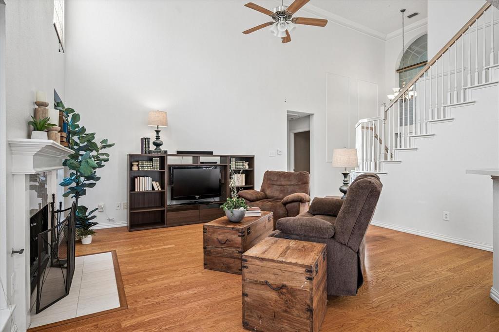 14592 Greenleaf Court Addison, TX 75001 - Photo 7 of 30 a living room with furniture a fireplace and a potted plant