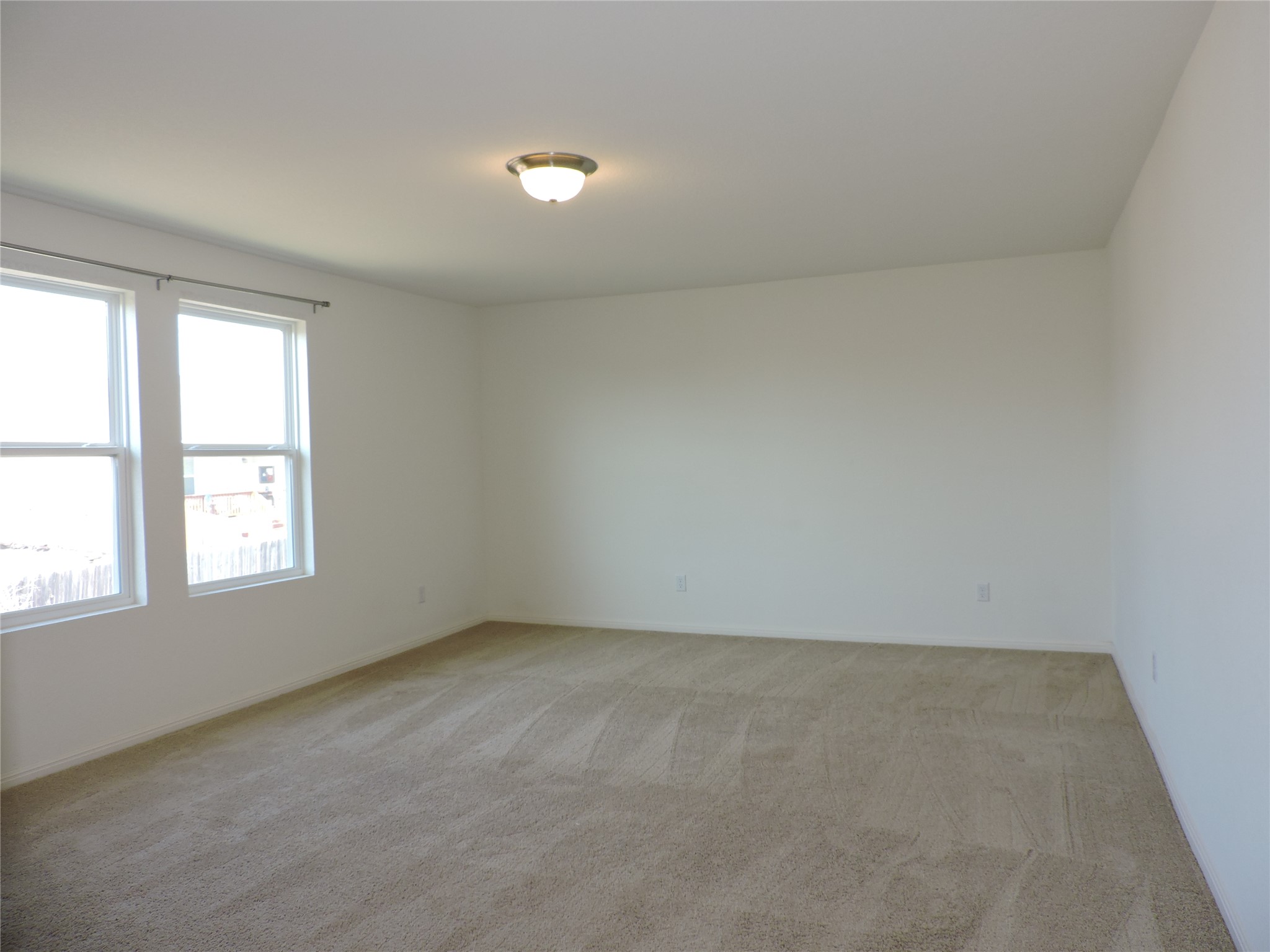 14120 Jeannette Rankin Rd Manor Manor, TX 78653 - Photo 11 of 25 Spare room with light colored carpet and baseboards