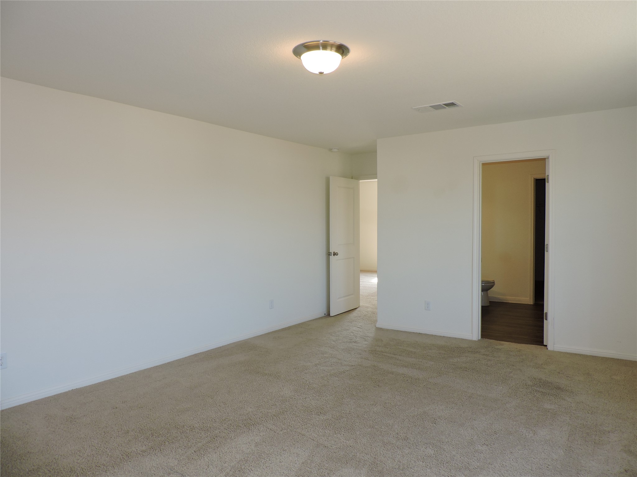 14120 Jeannette Rankin Rd Manor Manor, TX 78653 - Photo 12 of 25 Unfurnished bedroom with carpet floors and ensuite bath