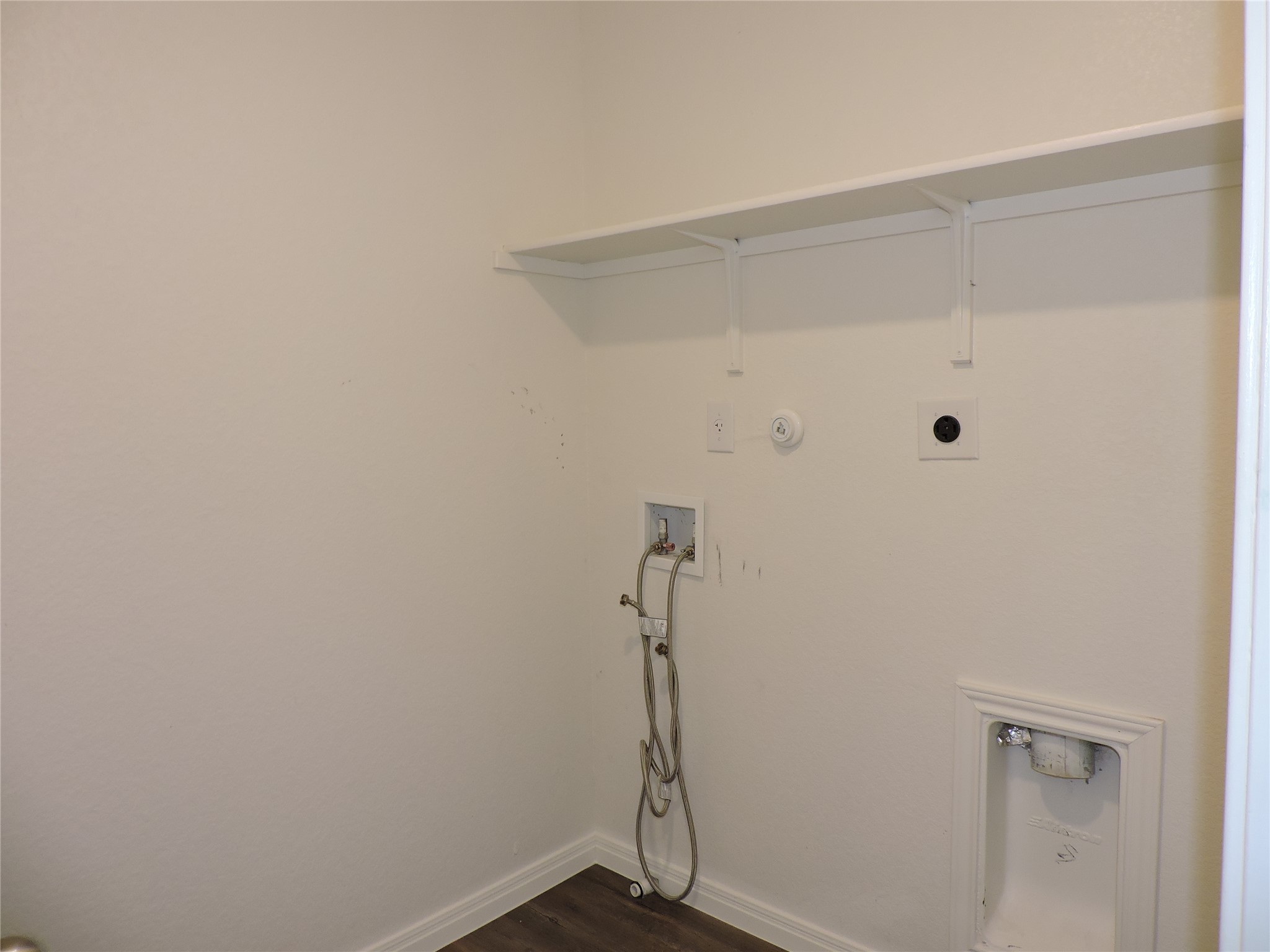 14120 Jeannette Rankin Rd Manor Manor, TX 78653 - Photo 16 of 25 Laundry room featuring hookup for a gas dryer, dark wood-type flooring, washer hookup, and electric dryer hookup