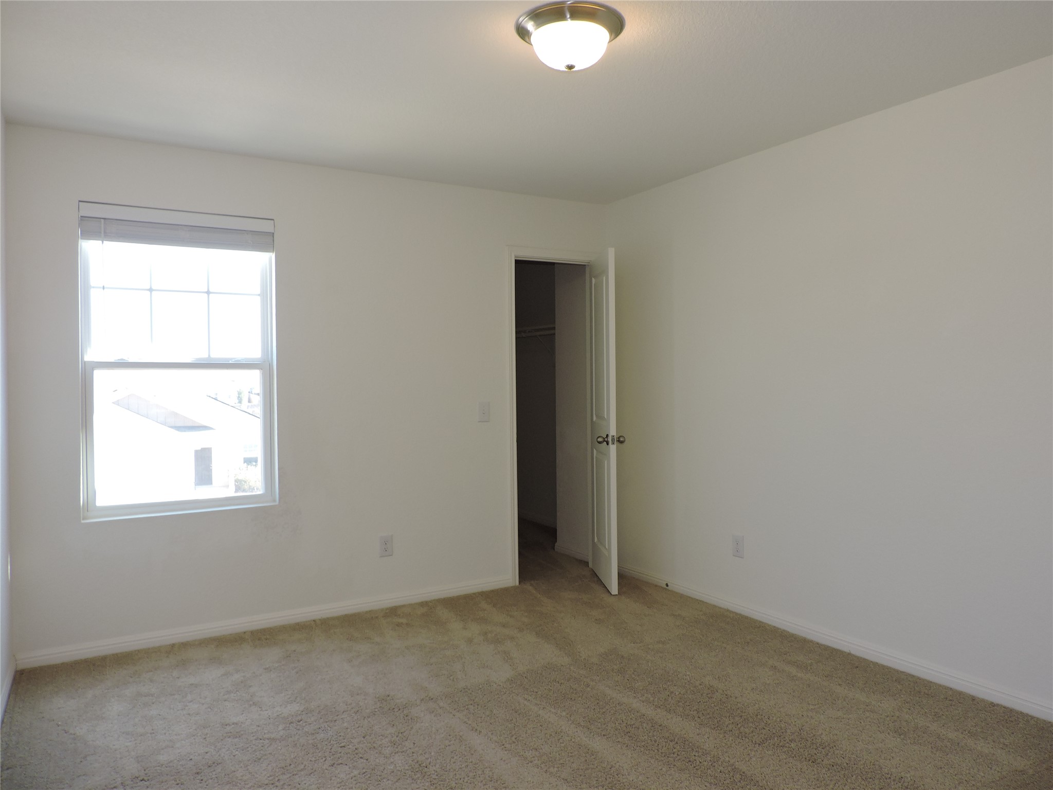 14120 Jeannette Rankin Rd Manor Manor, TX 78653 - Photo 19 of 25 Unfurnished bedroom featuring a spacious closet and carpet floors