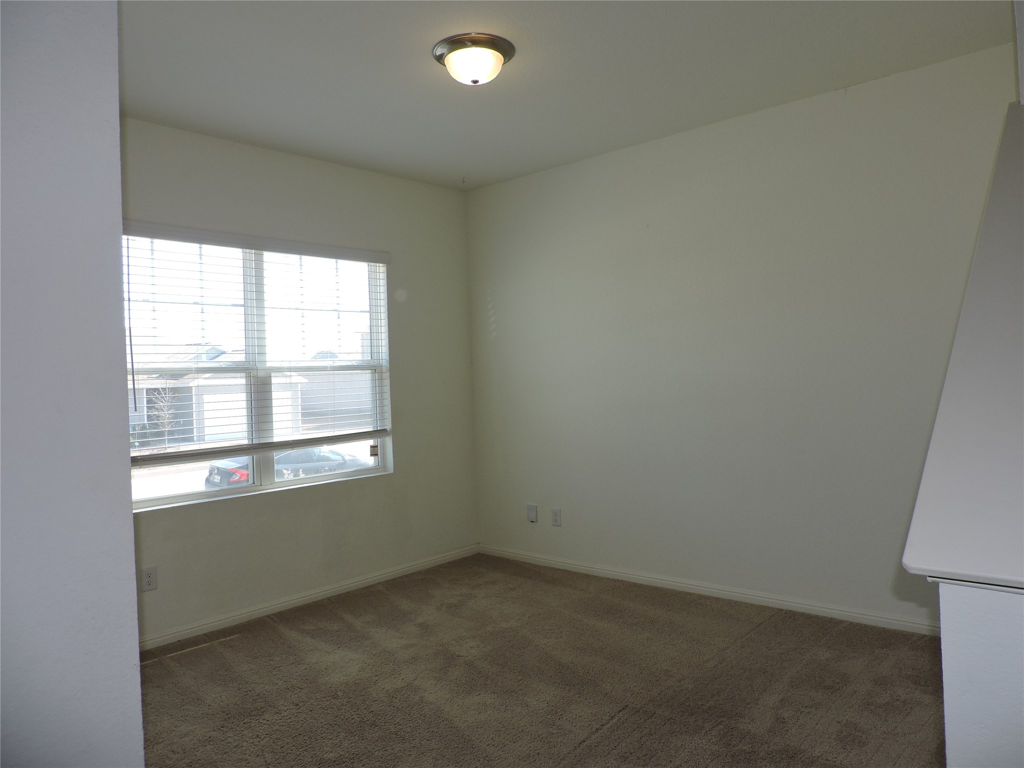 14120 Jeannette Rankin Rd Manor Manor, TX 78653 - Photo 2 of 25 Unfurnished room featuring dark carpet and baseboards