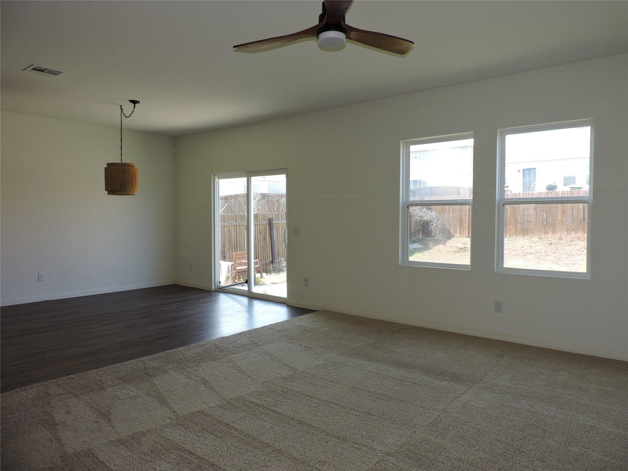 14120 Jeannette Rankin Rd Manor Manor, TX 78653 - Photo 7 of 25 Spare room featuring a ceiling fan and dark carpet
