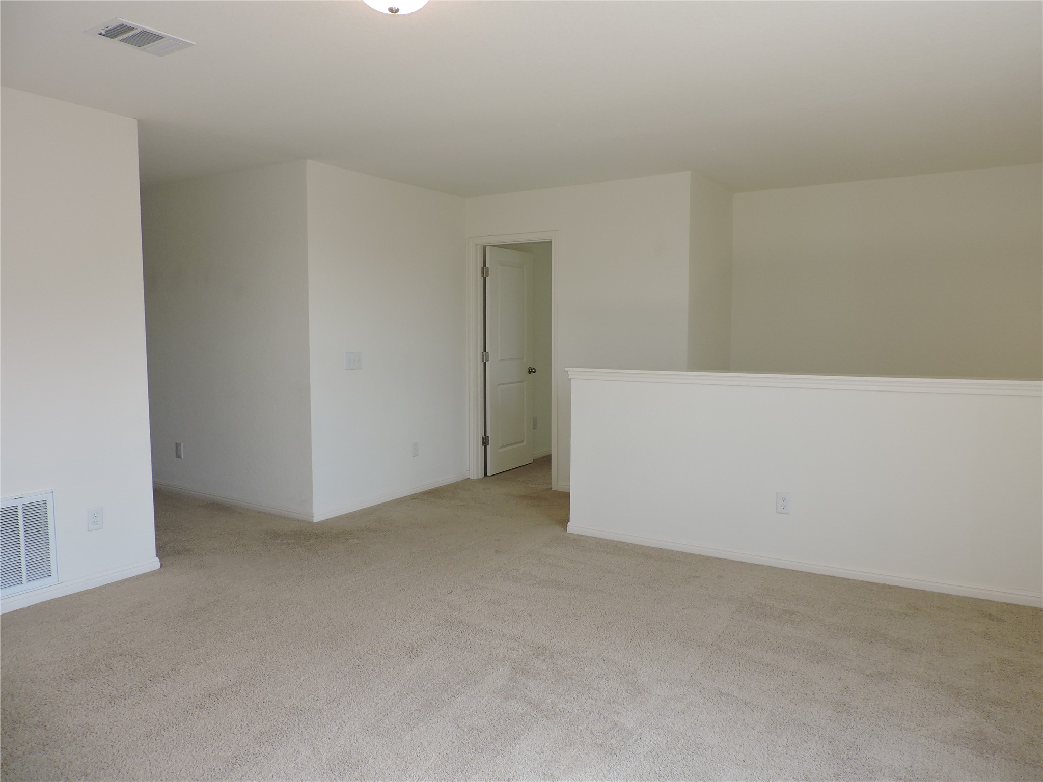 14120 Jeannette Rankin Rd Manor Manor, TX 78653 - Photo 9 of 25 Unfurnished room with light colored carpet and baseboards