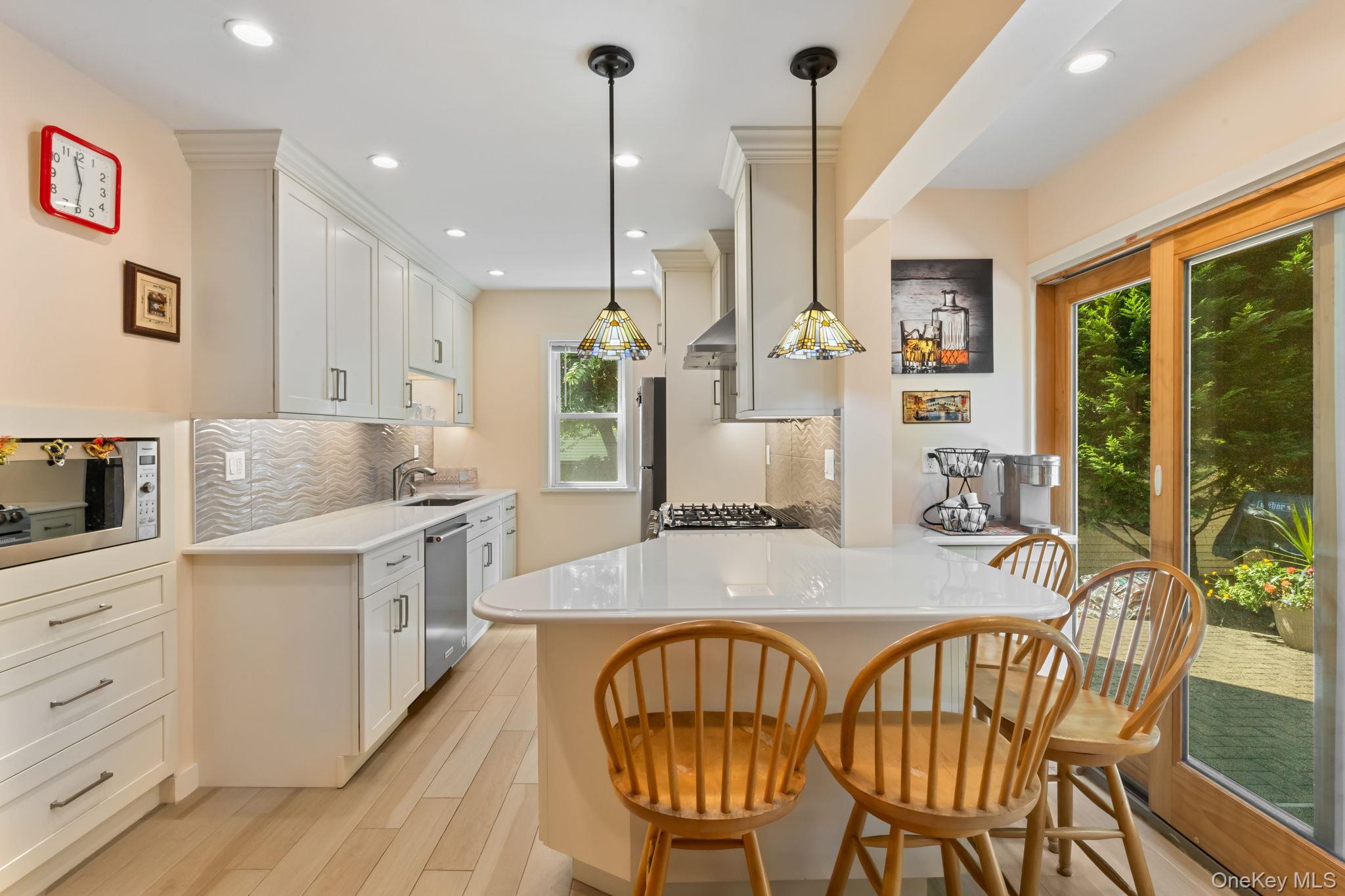 a kitchen with stainless steel appliances granite countertop a kitchen island a stove a table and chairs