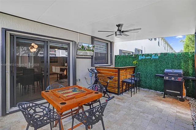 a patio with a table and chairs