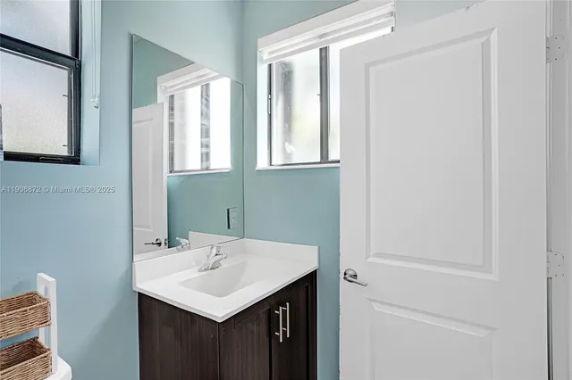 a bathroom with a sink a toilet and shower curtain