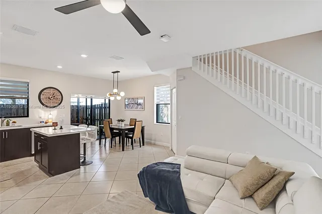 a living room with furniture a dining table and chairs