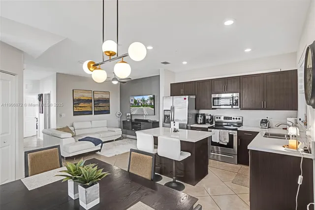 a dining room filled couch and a chandelier