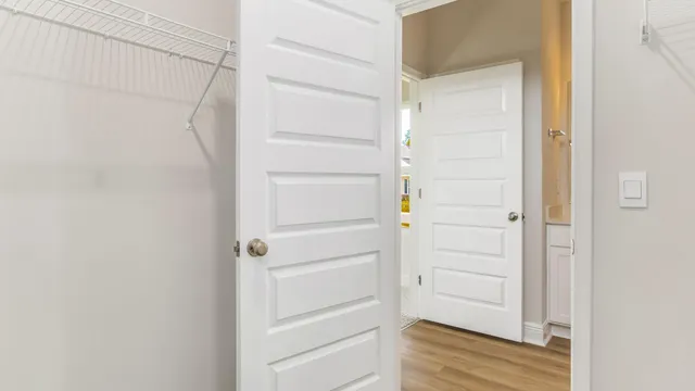 a view of walk in closet with empty racks