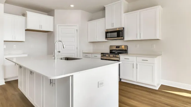 a kitchen with white cabinets stainless steel appliances and sink