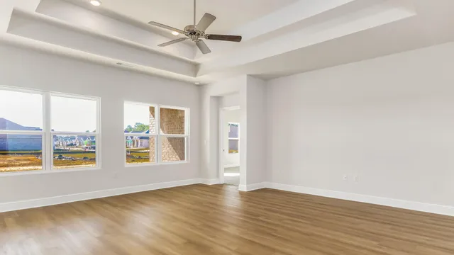 an empty room with window and wooden floor