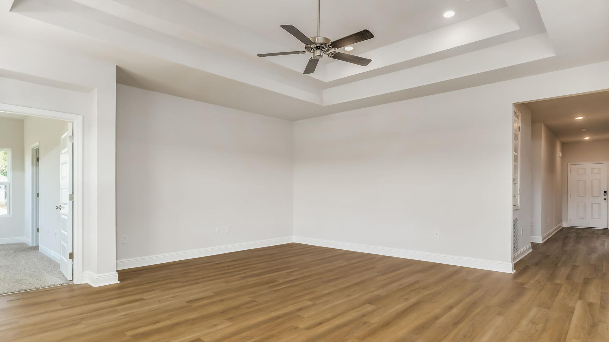 5622 Thatcher Road Crestview, FL 32539 - Photo 8 of 30 a view of a room with wooden floor and a ceiling fan