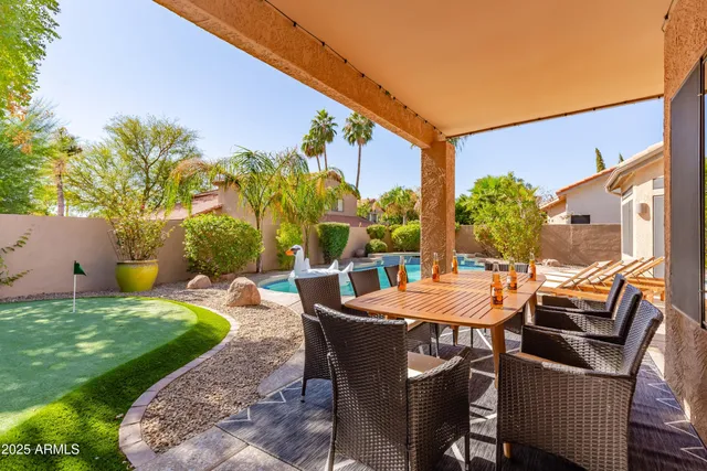 a view of a patio with table and chairs and potted plants
