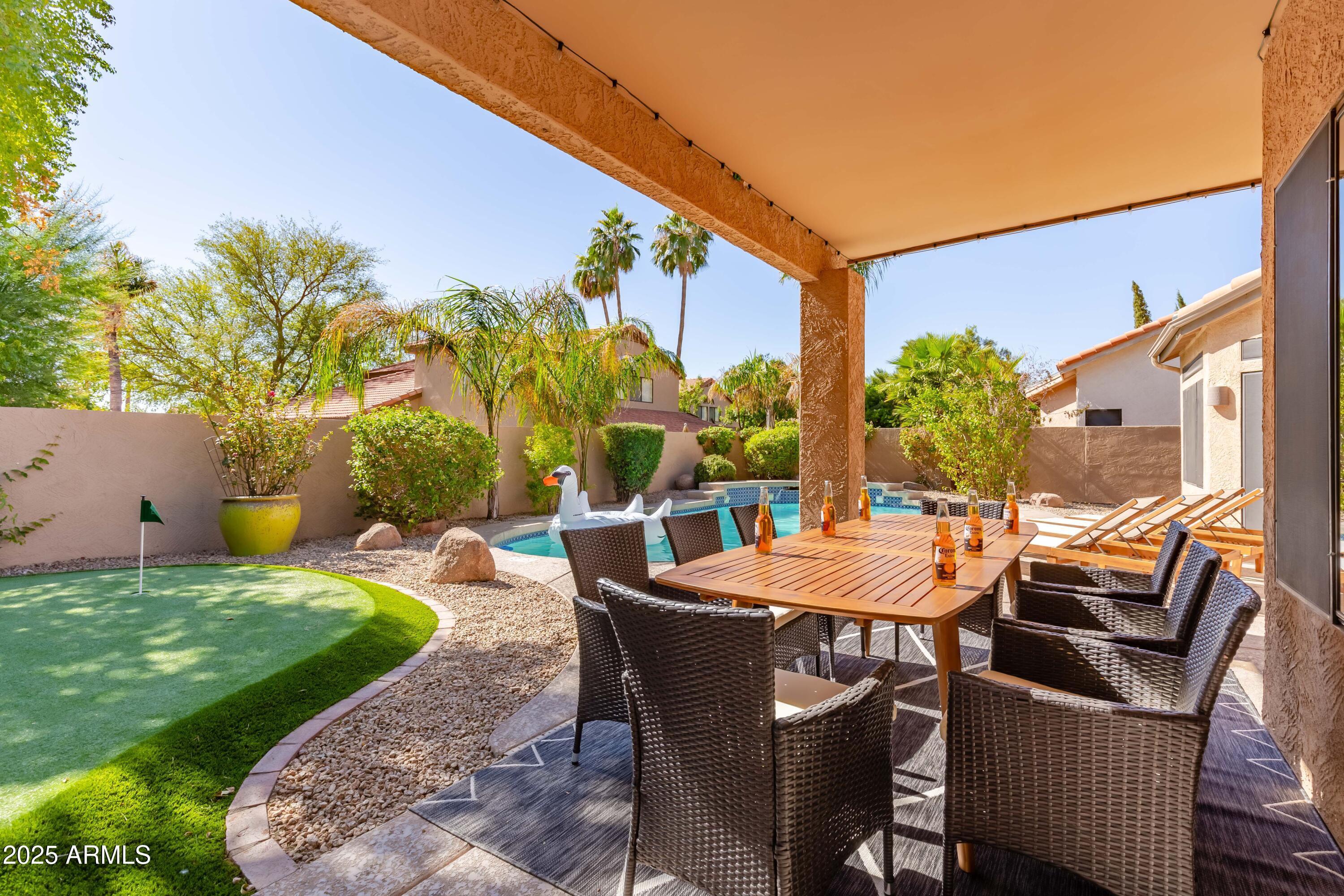 a view of a patio with table and chairs and potted plants