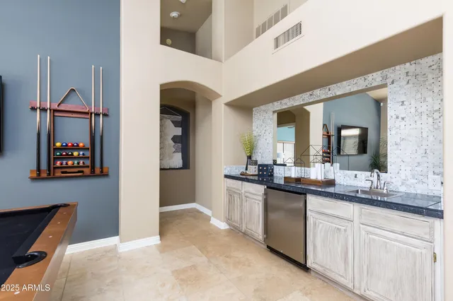 a kitchen with granite countertop a sink and cabinets