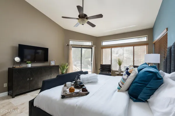 a living room with furniture a flat screen tv and a large window